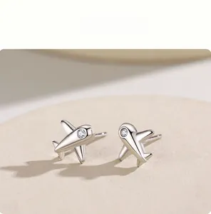 Gros plan de boucles d'oreilles avion en argent S925 poli serties d'un zircon brillant