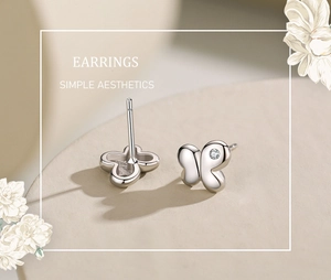 Detailed view of S925 sterling silver butterfly stud earrings with sparkling cubic zirconia