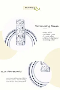 Macro detail of S925 sterling silver earring featuring three prong-set cubic zirconia stones