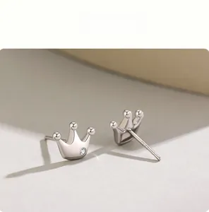 Detail view of S925 sterling silver crown studs with sparkling cubic zirconia accent