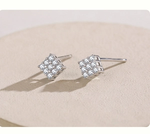 Detailed macro view of silver square stud earrings with nine shimmering cubic zirconia crystals