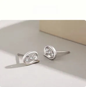 Macro shot of S925 sterling silver speech bubble earrings with three micro-inlaid zircons
