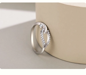 Macro shot of silver crisscross ring featuring micro-pave diamonds and elegant polished finish