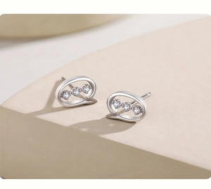 Close-up of S925 sterling silver speech bubble stud earrings with micro-inlaid cubic zirconia