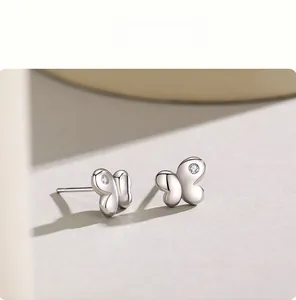 Close-up of minimalist S925 silver butterfly earrings with sparkling cubic zirconia stones