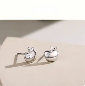 Detailed close-up of S925 sterling silver apple earrings with sparkling cubic zirconia