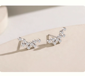 Macro shot of curved s925 silver bubble earrings featuring clear round cubic zirconia stones