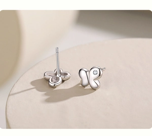 Detailed macro shot of s925 silver butterfly earrings with cubic zirconia stone