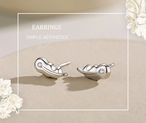 Macro detail of leaf-shaped S925 sterling silver stud earrings with sparkling zircon