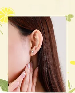 On-ear shot of minimalist S925 sterling silver star stud earrings on a female model