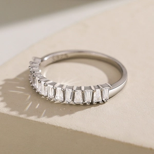 S925 sterling silver eternity ring with channel-set baguette cut crystals on stone base
