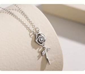 Macro detail of S925 sterling silver rose pendant with sparkling zircon leaf accents