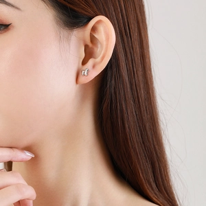Elegant s925 silver butterfly stud earring with zircon on model ear, side view