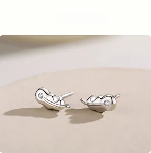 Detail of S925 sterling silver leaf stud earrings with micro-inlaid zircon accents