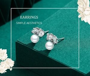 Detail view of S925 silver pearl stud earrings with sparkling cubic zirconia clusters