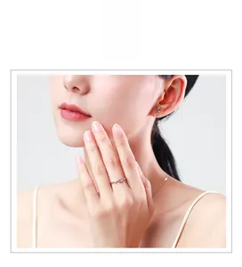 Close-up of minimalist s925 sterling silver snake-shaped ring and earring set on model
