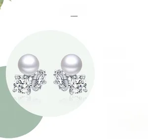 Detail of s925 silver pearl earrings with zircon inlay showing polished surface