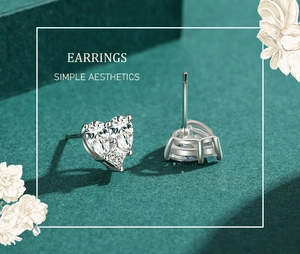 Macro shot of S925 silver heart stud earrings featuring clear pavé cubic zirconia gems