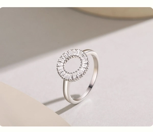 Macro shot of silver S925 ring with baguette-cut zircons on a minimalist background