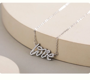 Macro shot of S925 silver Love pendant necklace with sparkling micro-paved zircons