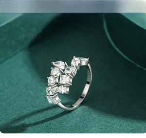 Macro view of S925 sterling silver ring with mixed cut cubic zirconia on green surface