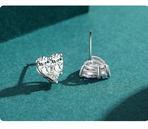 Detailed macro view of S925 sterling silver heart studs with pave-set sparkling cubic zirconia