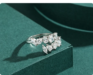 Macro shot of S925 silver ring featuring mixed-cut zircons on a green velvet surface