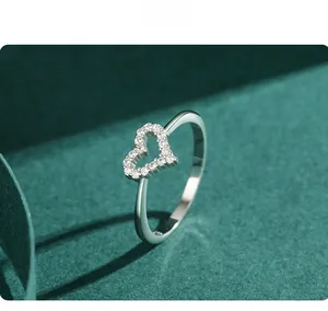 Macro shot of S925 sterling silver hollow heart ring featuring delicate pave-set zircons