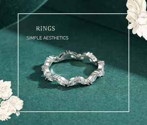 Macro view of marquise cut silver ring displayed on premium green velvet fabric