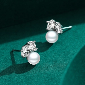 Elegant S925 silver pearl earrings with micro-inlaid diamonds on a green velvet surface