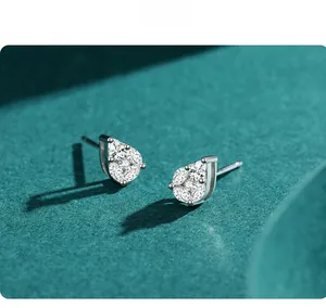Macro shot of S925 silver teardrop earrings with pavé set zircon on dark background