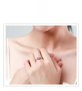 Close-up of s925 silver four-leaf clover ring with diamonds worn on female finger