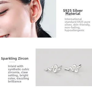Detail view of S925 sterling silver snake earrings featuring cubic zirconia claw setting