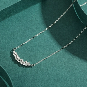 S925 sterling silver necklace with marquise and round cut crystals on green background