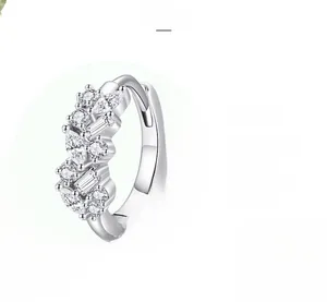 Detailed macro view of S925 silver huggie earrings with polished cubic zirconia settings