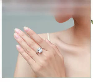 Close-up of luxury S925 silver ring featuring a 3ct emerald cut diamond and halo setting