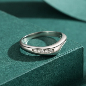 Polished S925 sterling silver ring with pavé-set zircons on a dark green base