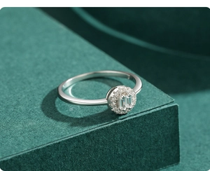 Macro side view of S925 sterling silver ring with halo crystals on green box