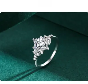 Detailed close-up of a square zircon ring on a green velvet background with silver band