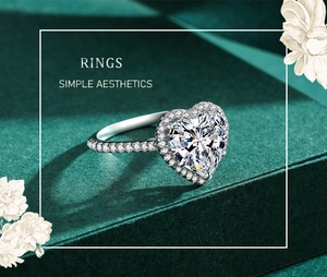Macro view of heart-shaped diamond ring with pavé halo on dark green textured surface