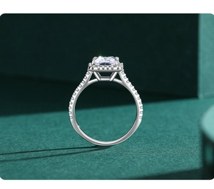 Macro view of square cut 3ct diamond ring with halo setting on emerald geometric background