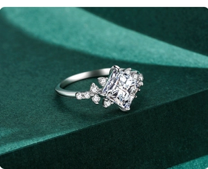 Macro shot of princess cut cubic zirconia ring with side stone leaf detailing