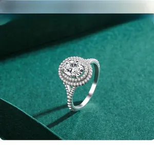 Macro detail of oval cut diamond ring with double halo setting on dark leather box