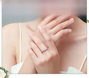 Detail of s925 silver three-stone ring with round and marquise-cut zircon on finger