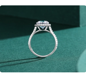 Close-up of a 5 carat round brilliant diamond ring with a halo setting and pavé band