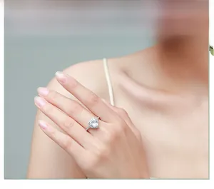 Close-up of luxury S925 sterling silver heart-shaped halo engagement ring on hand