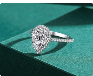 Macro detail of luxury pear cut 3ct cubic zirconia ring with diamond halo and pavé band
