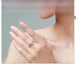 Close-up of s925 silver ring featuring halo-set rectangular zircon on female finger