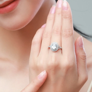 Elegant S925 sterling silver ring with 5-carat oval halo simulated diamond on model's hand