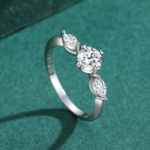 S925 sterling silver four-prong diamond ring with marquise side stones on green background